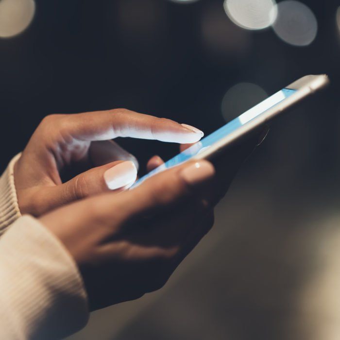 Person using a smartphone for data, airtime and digital services
